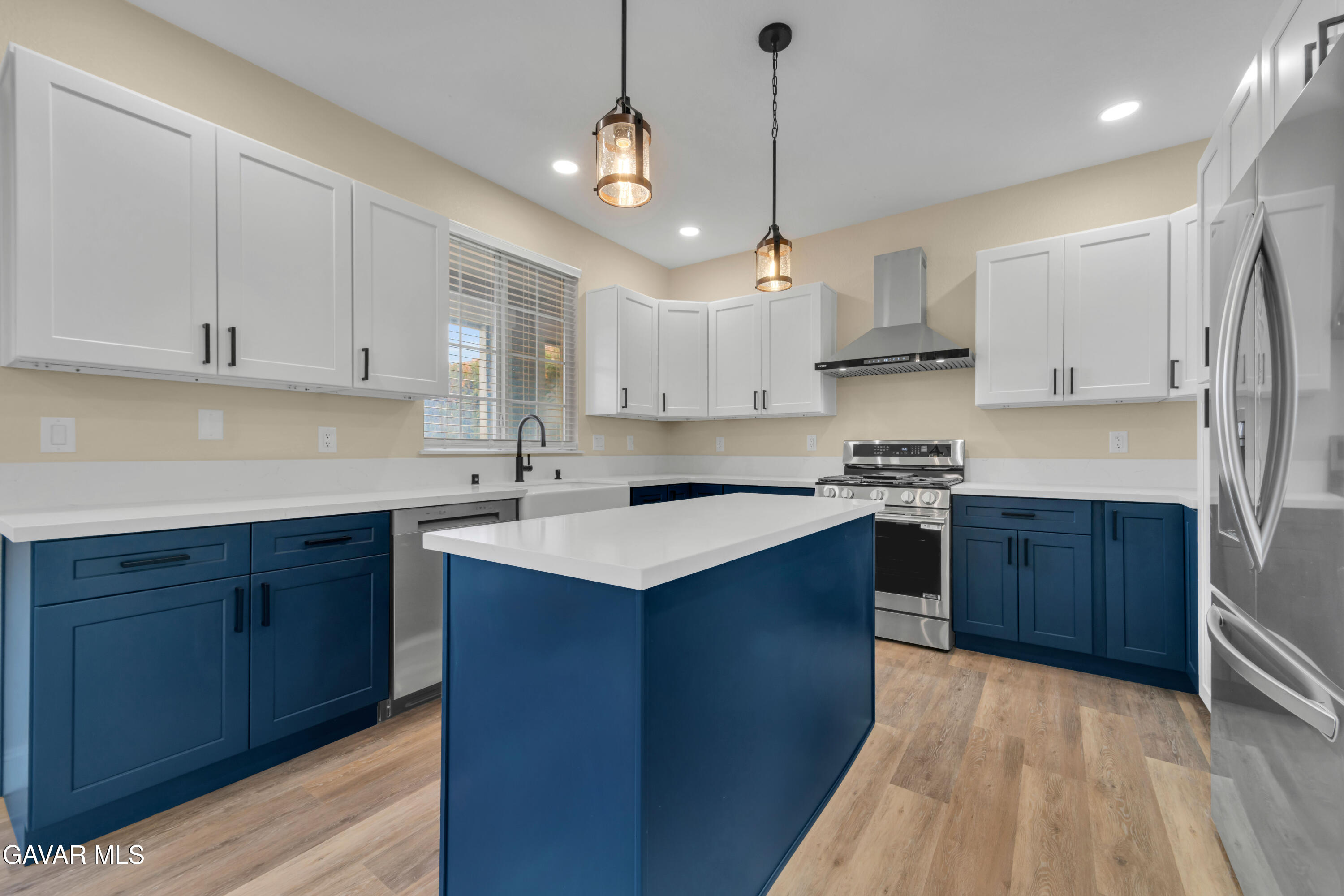 43323 Honeybee Lane Lancaster, CA 93536 - Photo 5 of 32 a kitchen with stainless steel appliances granite countertop a sink a stove and a refrigerator