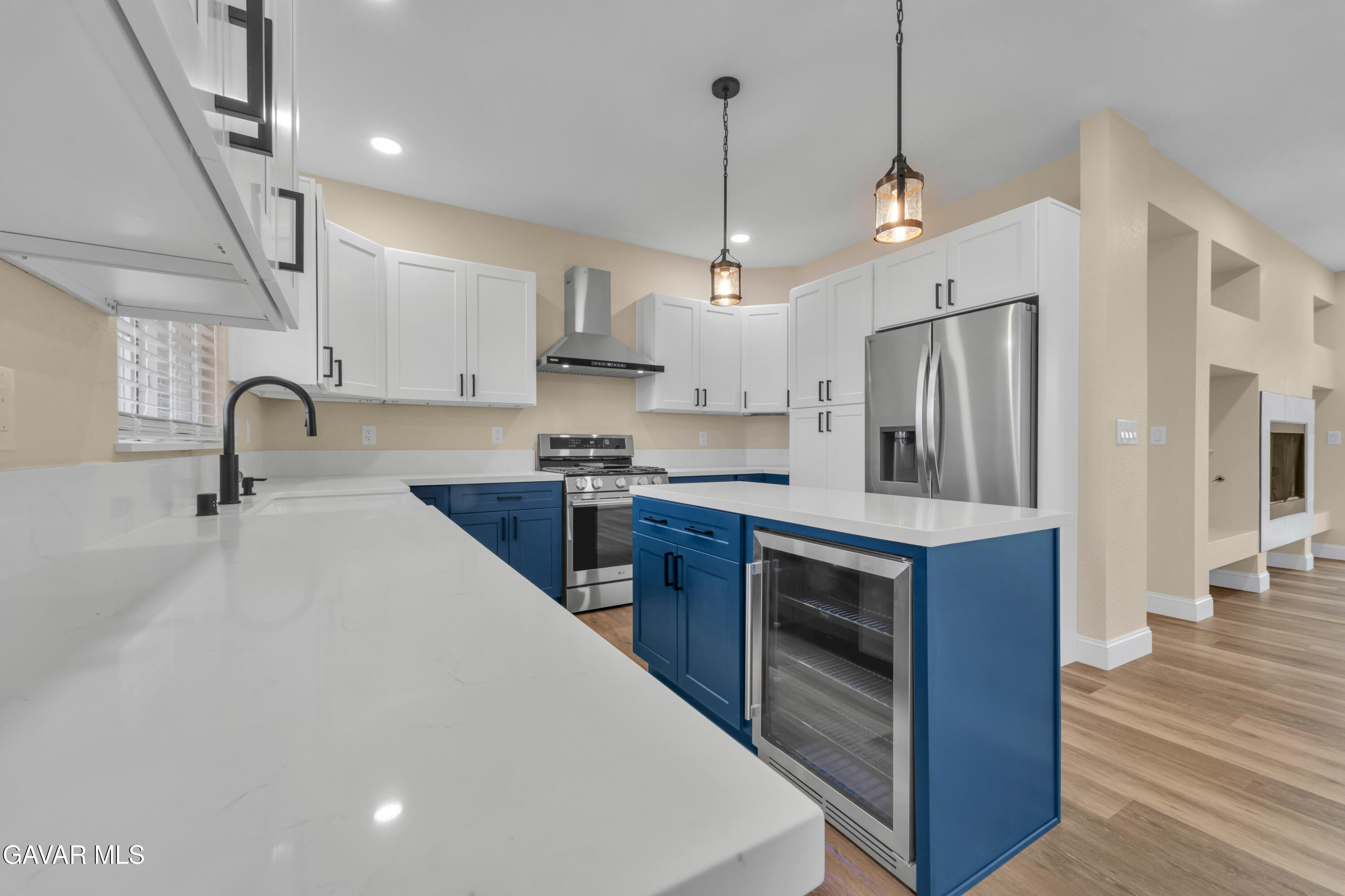 43323 Honeybee Lane Lancaster, CA 93536 - Photo 6 of 32 a kitchen with stainless steel appliances a stove a sink dishwasher a refrigerator and a oven with wooden floor