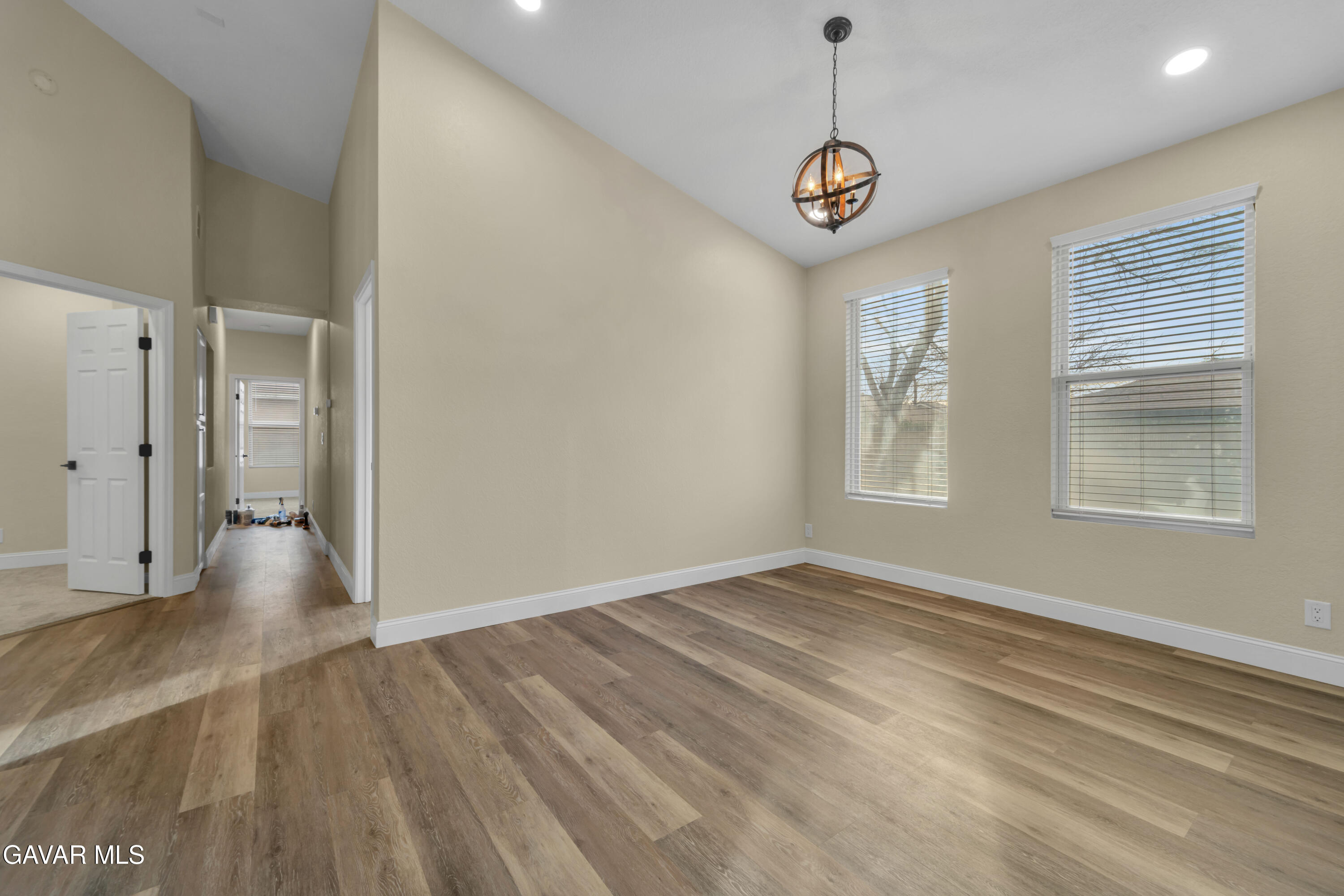 43323 Honeybee Lane Lancaster, CA 93536 - Photo 8 of 32 a view of an empty room with window and wooden floor