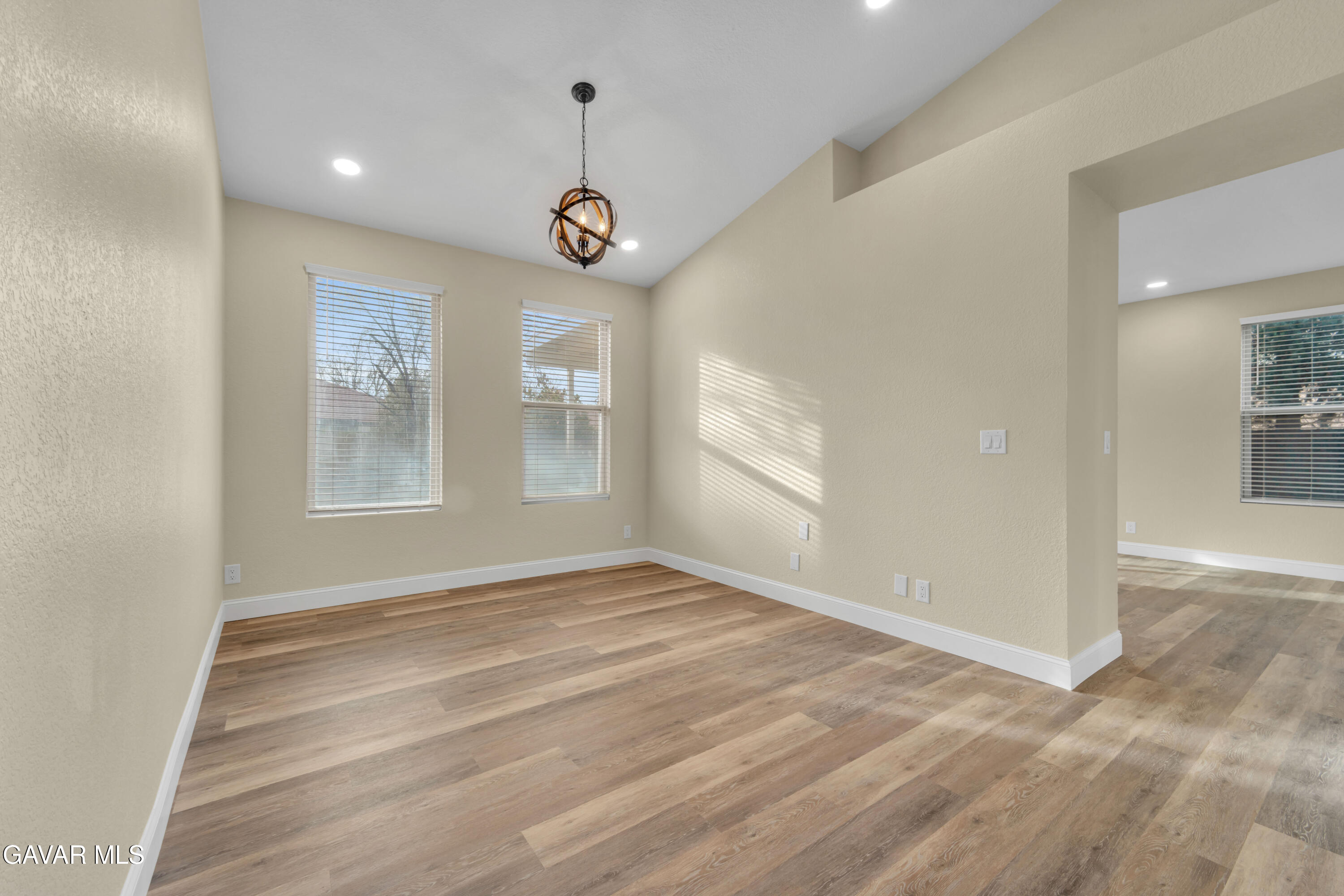43323 Honeybee Lane Lancaster, CA 93536 - Photo 9 of 32 an empty room with wooden floor and windows