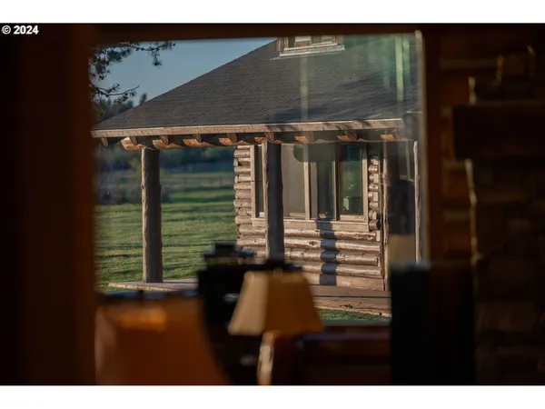 a view of swimming pool with lawn chairs and plants