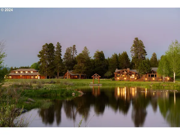 a backyard of a house with a yard and outdoor seating