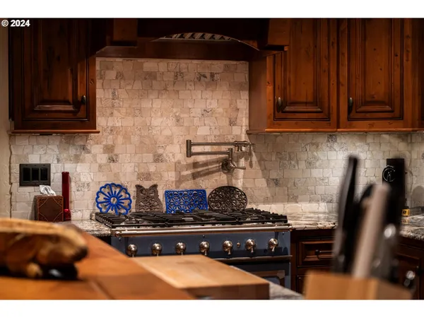 a kitchen with a stove and cabinets