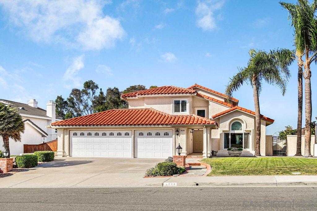 5058 Frazee Road Oceanside, CA 92057 - Photo 1 of 25 a view of a white house with a small yard and palm trees