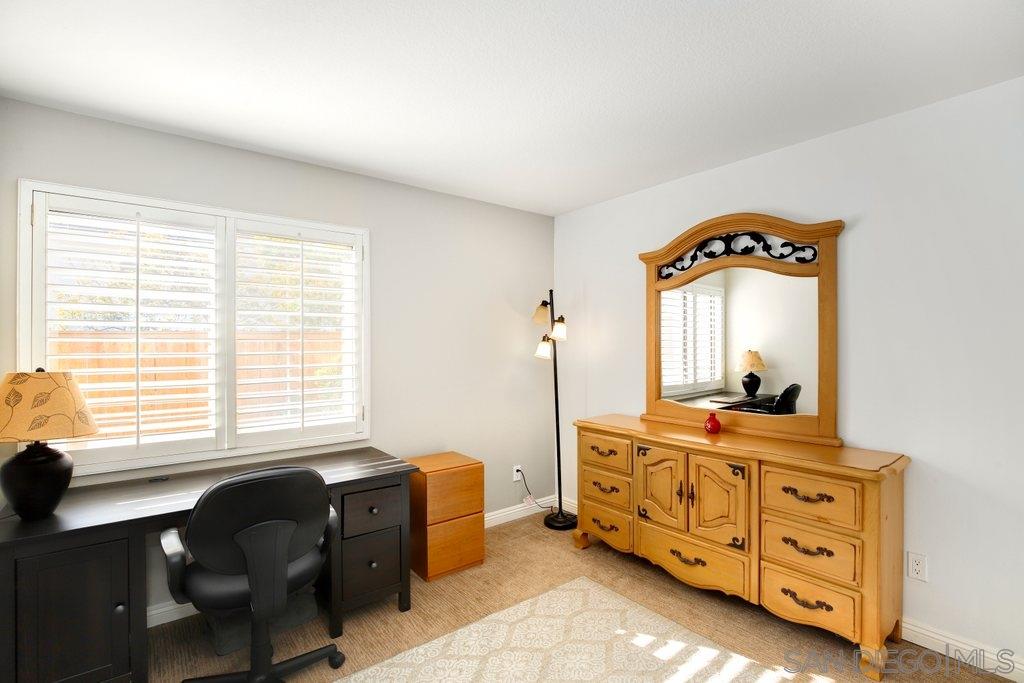 5058 Frazee Road Oceanside, CA 92057 - Photo 17 of 25 a bedroom with a bed and a mirror on the dresser