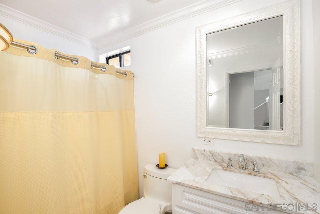 5058 Frazee Road Oceanside, CA 92057 - Photo 18 of 25 a bathroom with a sink and a mirror