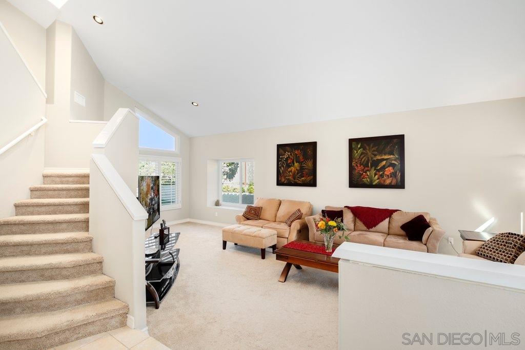 5058 Frazee Road Oceanside, CA 92057 - Photo 3 of 25 a living room with furniture and stairs