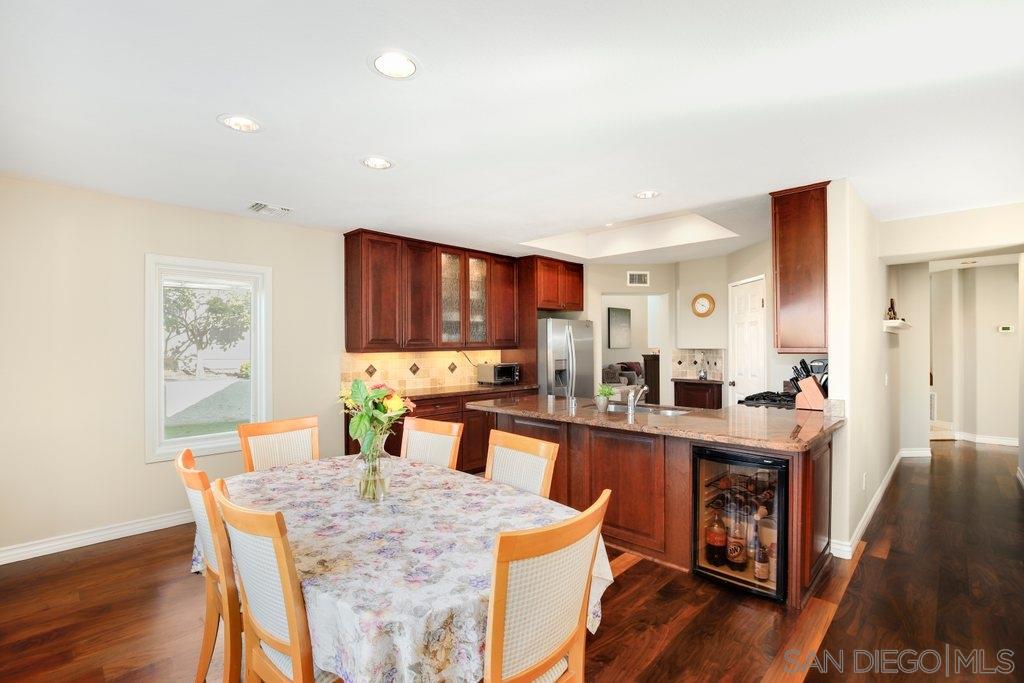 5058 Frazee Road Oceanside, CA 92057 - Photo 4 of 25 a kitchen with a table and chairs in it