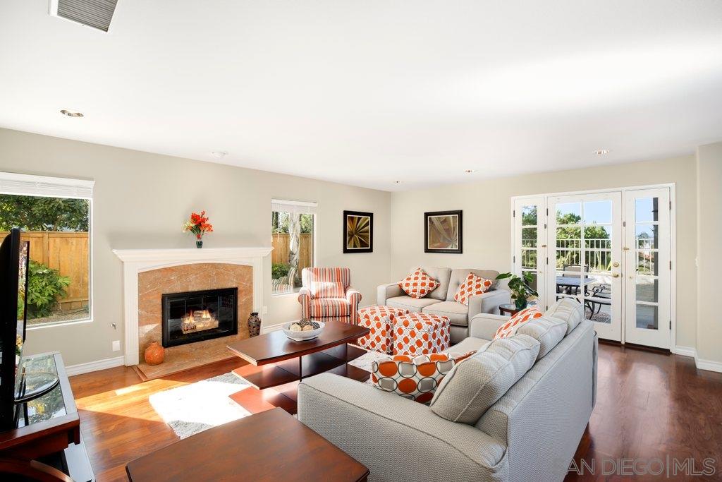 5058 Frazee Road Oceanside, CA 92057 - Photo 8 of 25 a living room with furniture and a fireplace