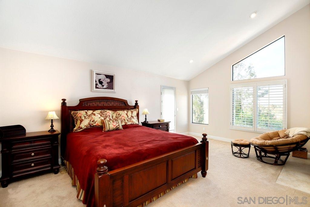 5058 Frazee Road Oceanside, CA 92057 - Photo 10 of 25 a spacious bedroom with a bed a couch and large window