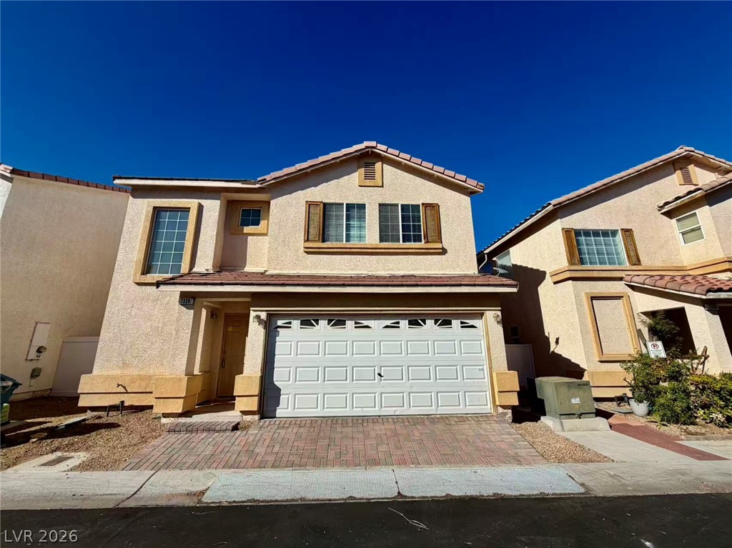 7326 Dicentra Road Las Vegas, NV 89113 - Photo 1 of 18 Classic stucco exterior showcases a two-story design complete with an integrated garage and tile roof.