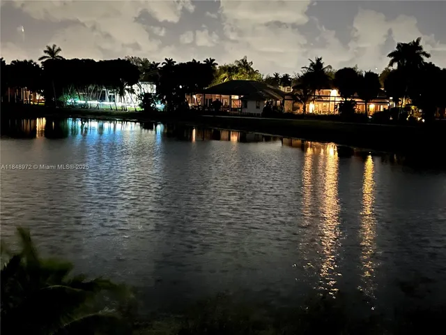 a front view of house with yard and trees around