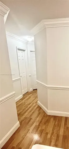 a view of a room with wooden floor