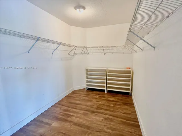 a view of room with stairs and wooden floor