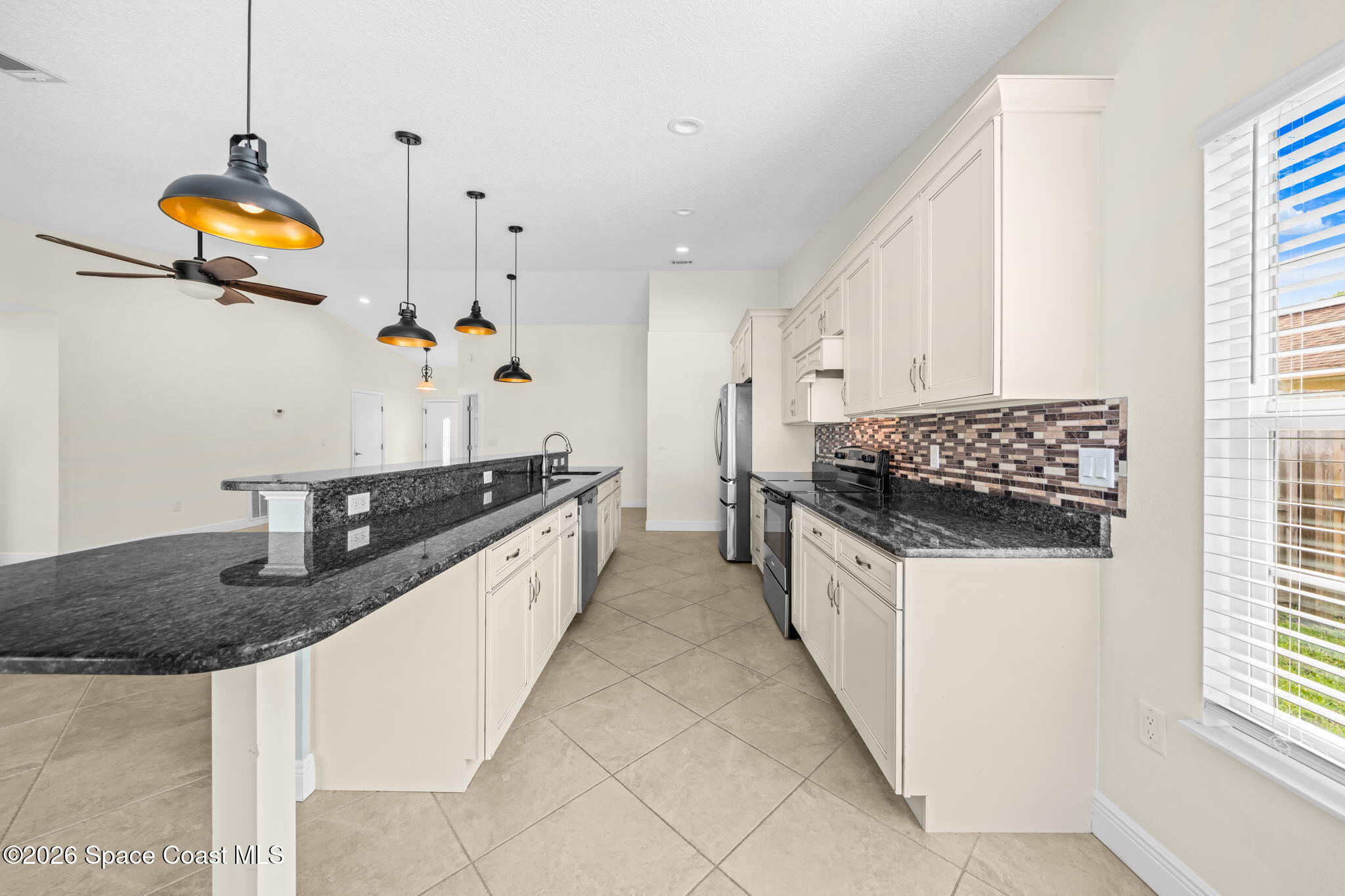 1236 Walnut Grove Way Rockledge, FL 32955 - Photo 11 of 43 a kitchen with stainless steel appliances granite countertop a sink a stove and a wooden floors