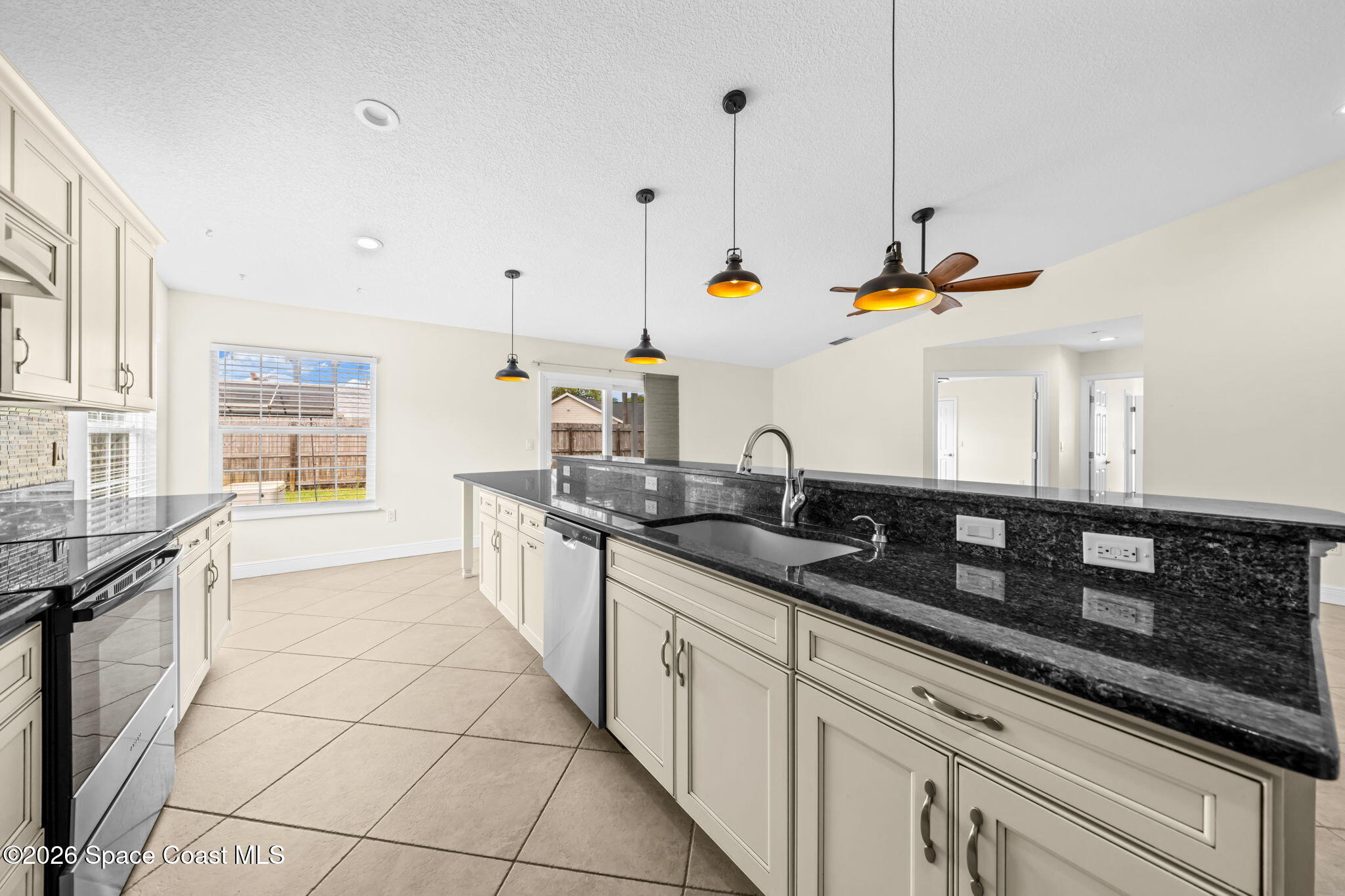 1236 Walnut Grove Way Rockledge, FL 32955 - Photo 13 of 43 a kitchen with stainless steel appliances granite countertop a sink a stove and a wooden floors