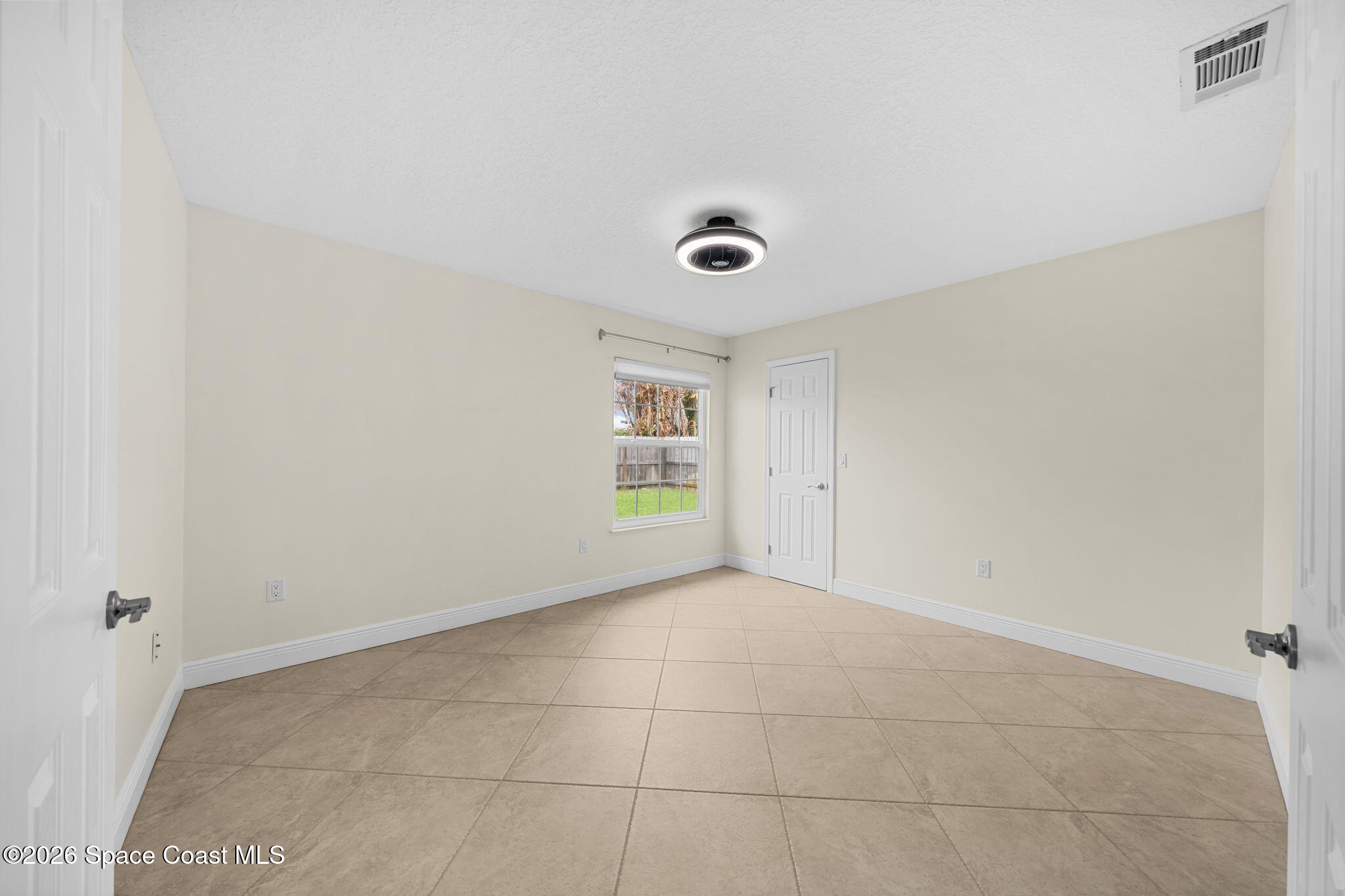1236 Walnut Grove Way Rockledge, FL 32955 - Photo 14 of 43 a view of an empty room with a window