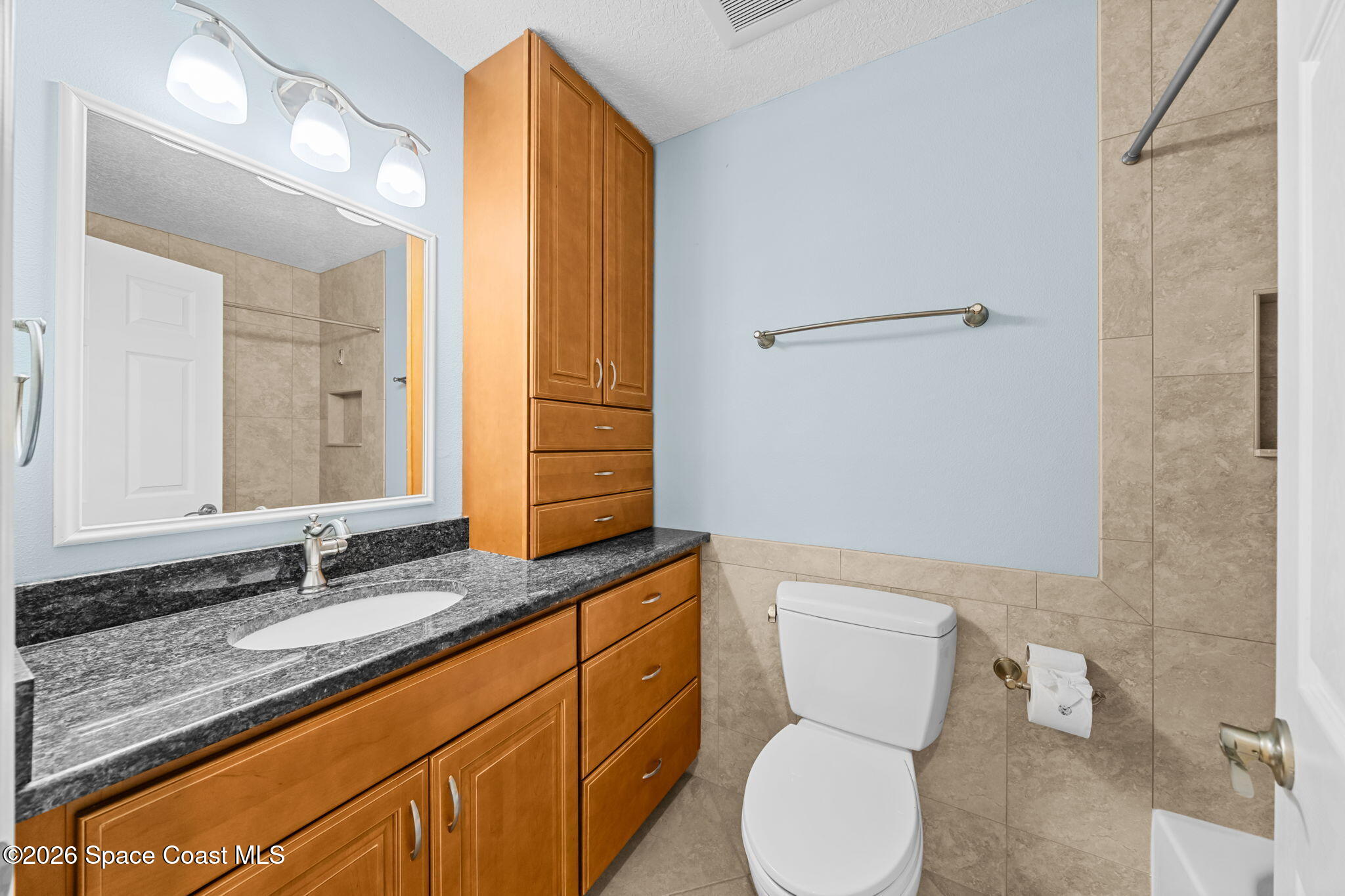 1236 Walnut Grove Way Rockledge, FL 32955 - Photo 17 of 43 a bathroom with a granite countertop toilet sink and mirror