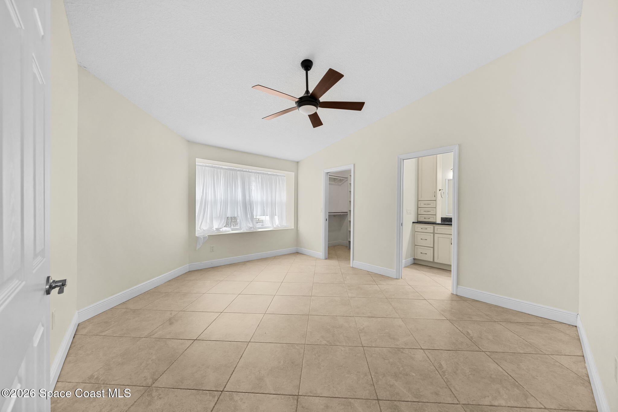 1236 Walnut Grove Way Rockledge, FL 32955 - Photo 22 of 43 a view of n empty room with a ceiling fan and window