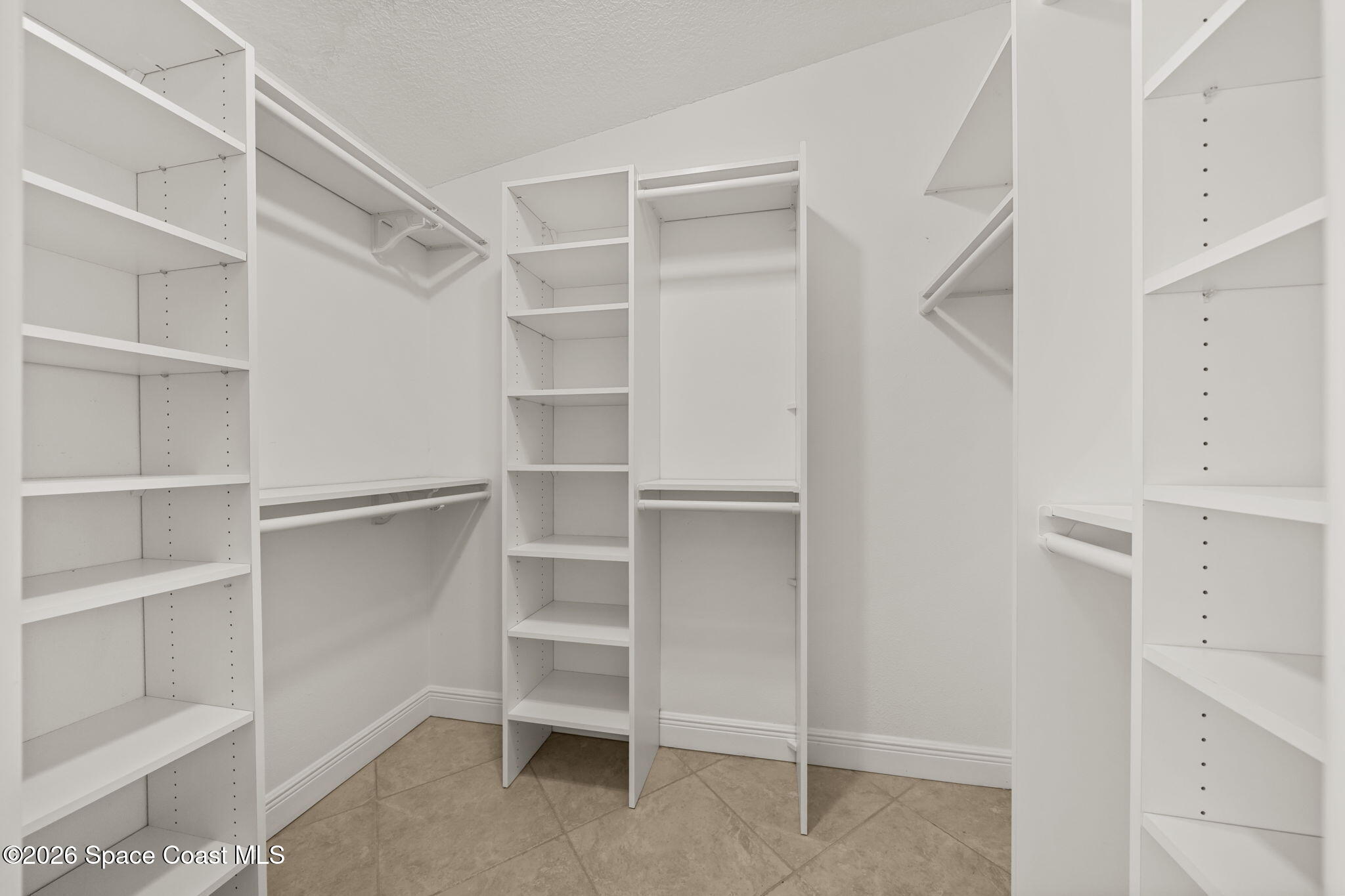 1236 Walnut Grove Way Rockledge, FL 32955 - Photo 24 of 43 a view of walk in closet with empty racks