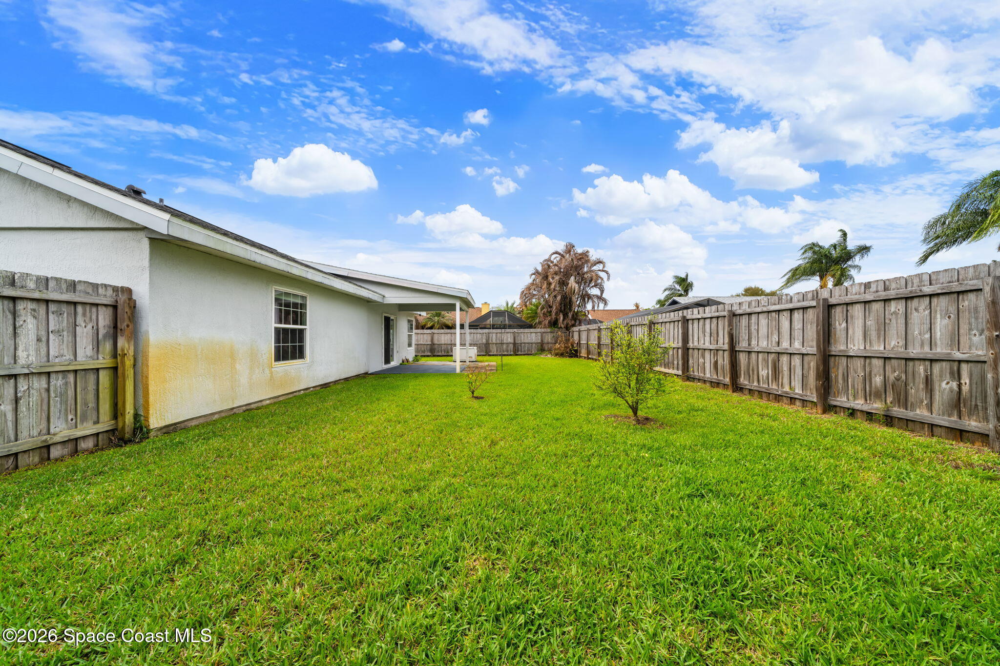 1236 Walnut Grove Way Rockledge, FL 32955 - Photo 28 of 43 a view of a backyard with a garden