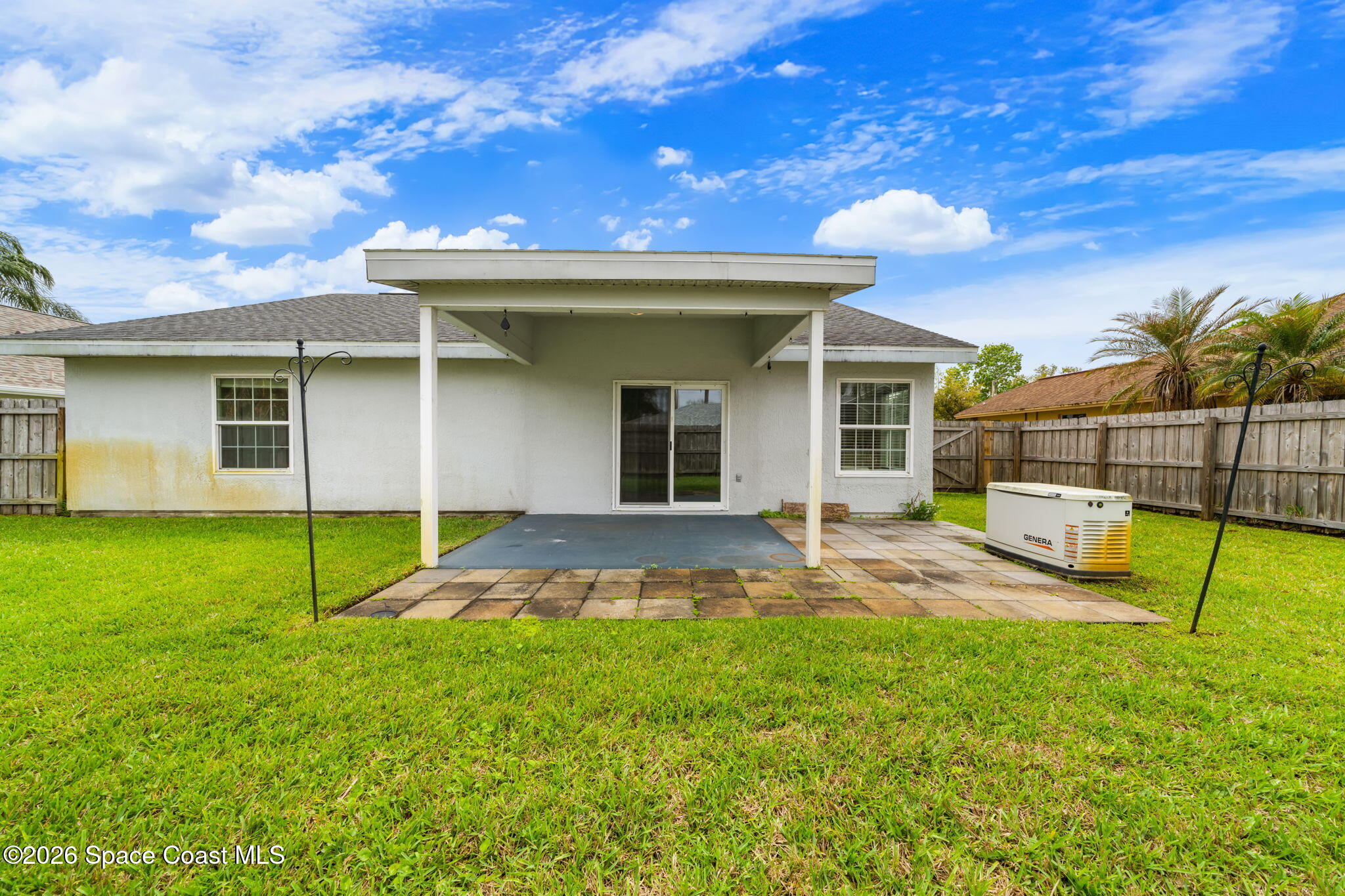 1236 Walnut Grove Way Rockledge, FL 32955 - Photo 30 of 43 a view of a backyard with a barbeque grill and plants