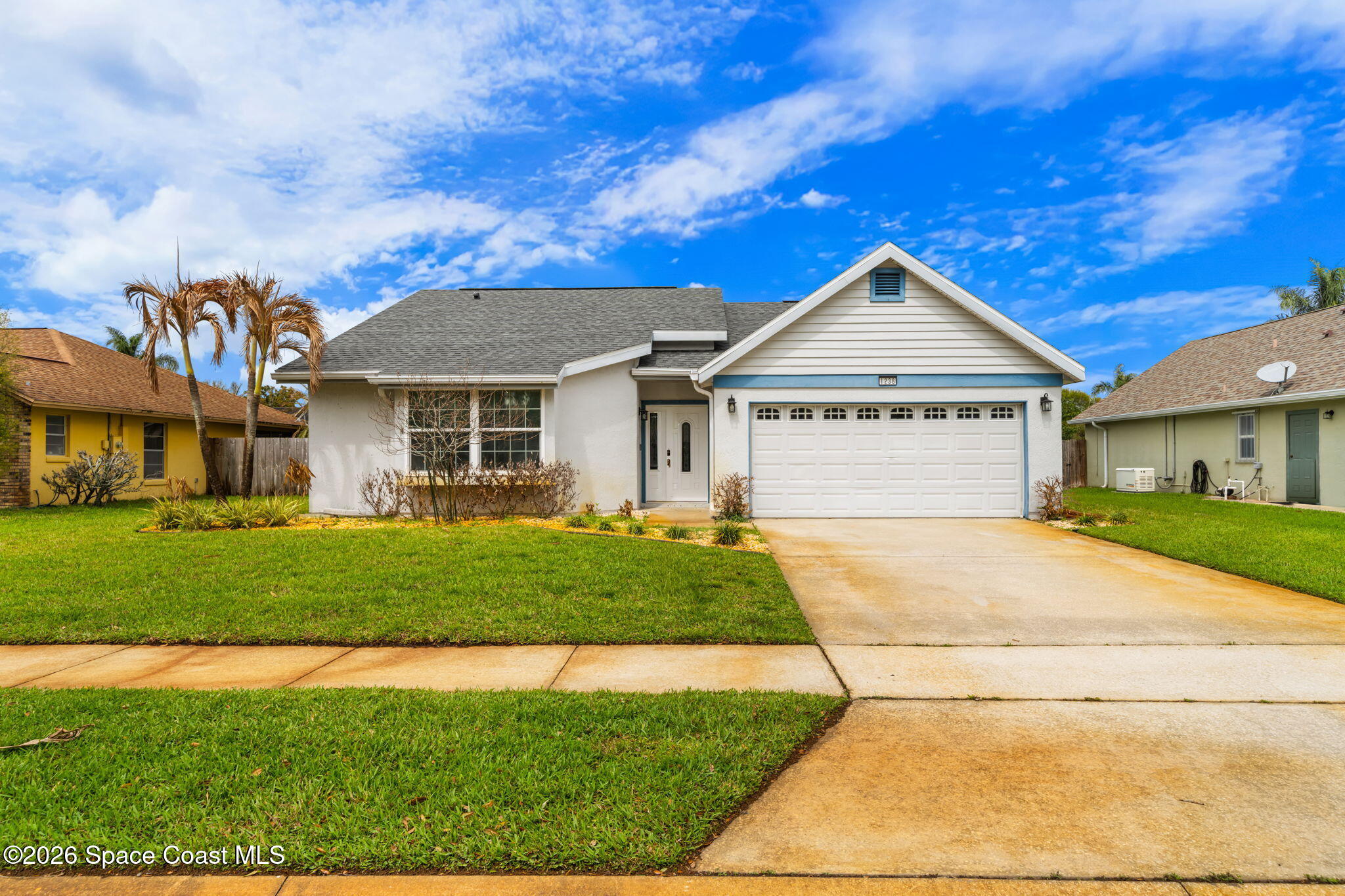 1236 Walnut Grove Way Rockledge, FL 32955 - Photo 3 of 43 a front view of a house with a yard and garage