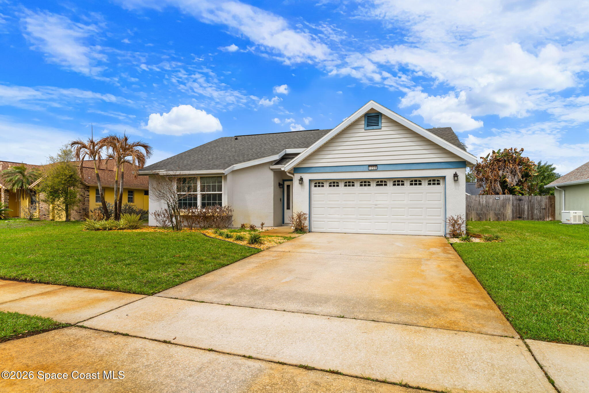 1236 Walnut Grove Way Rockledge, FL 32955 - Photo 40 of 43 a front view of a house with a yard and garage