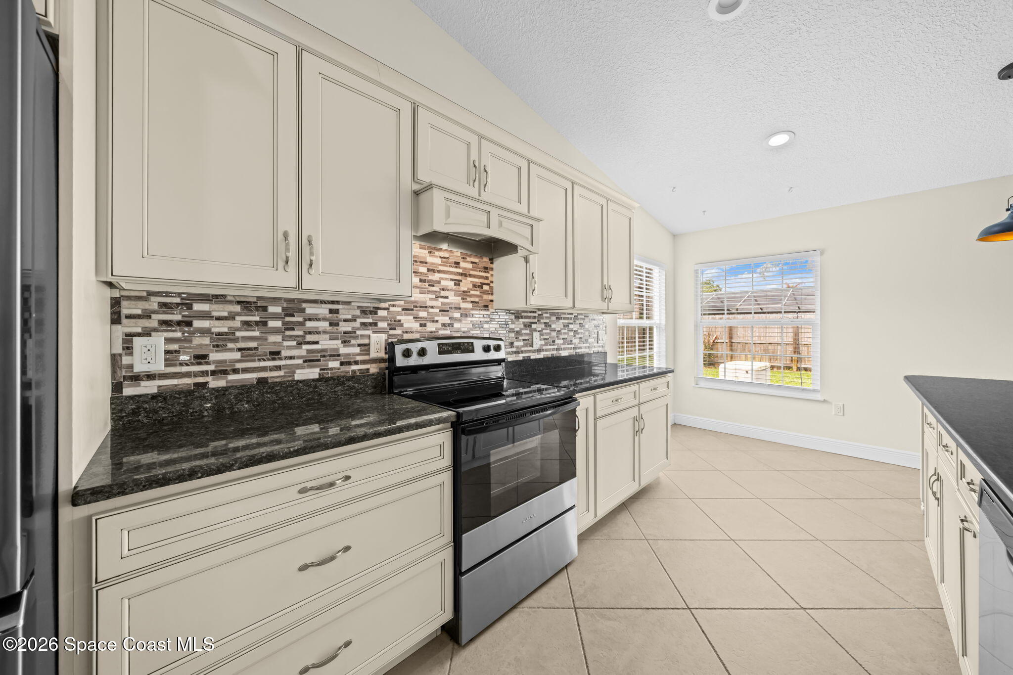 1236 Walnut Grove Way Rockledge, FL 32955 - Photo 4 of 43 a kitchen with granite countertop white cabinets and white appliances