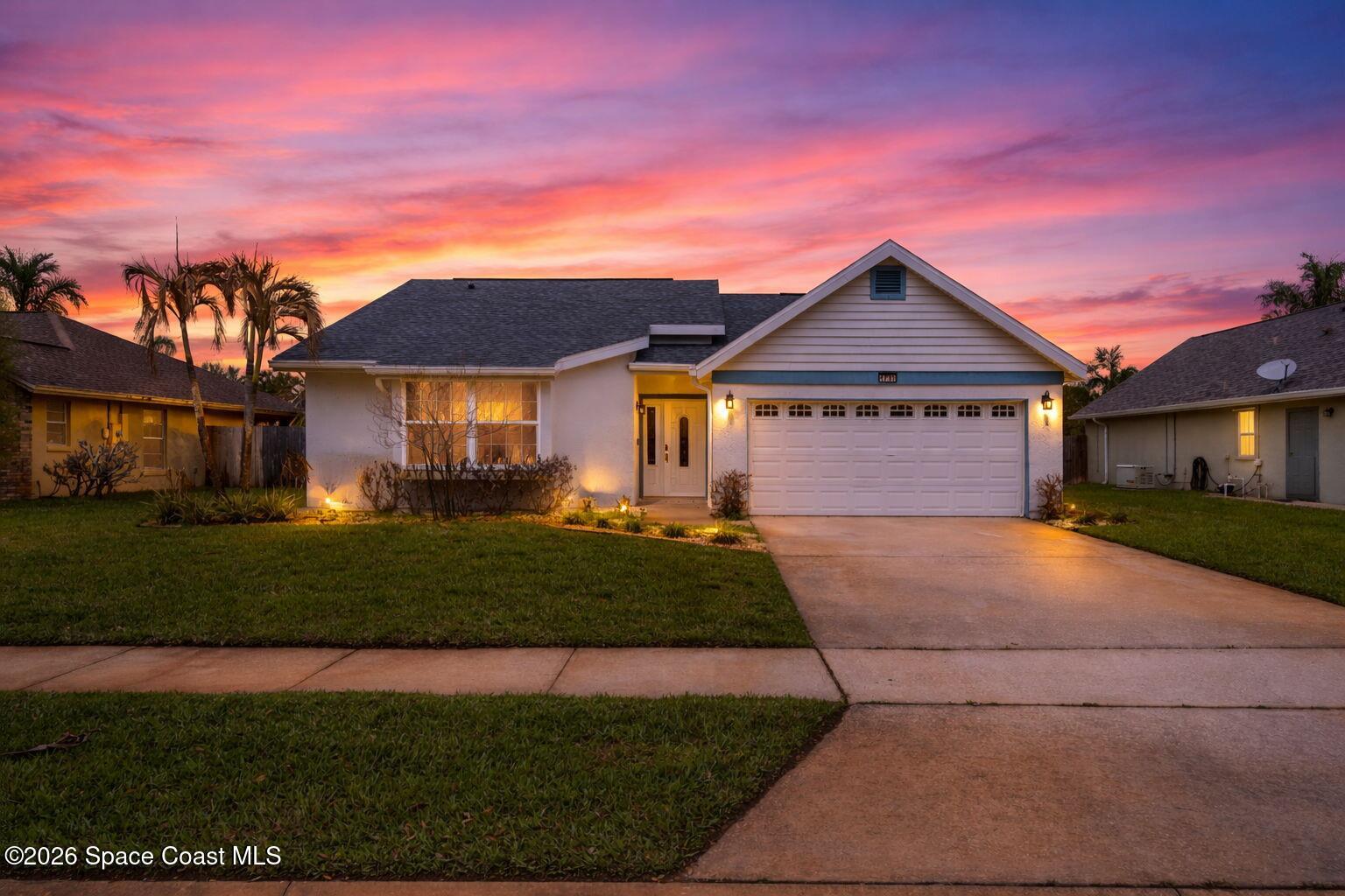 1236 Walnut Grove Way Rockledge, FL 32955 - Photo 43 of 43 a front view of a house with a garden