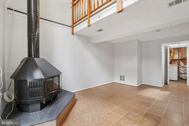a living room with a fireplace furniture and a window