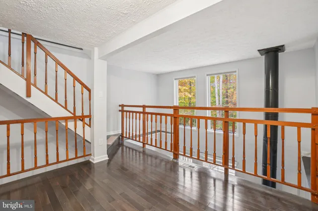 a view of staircase with wooden floor and a window