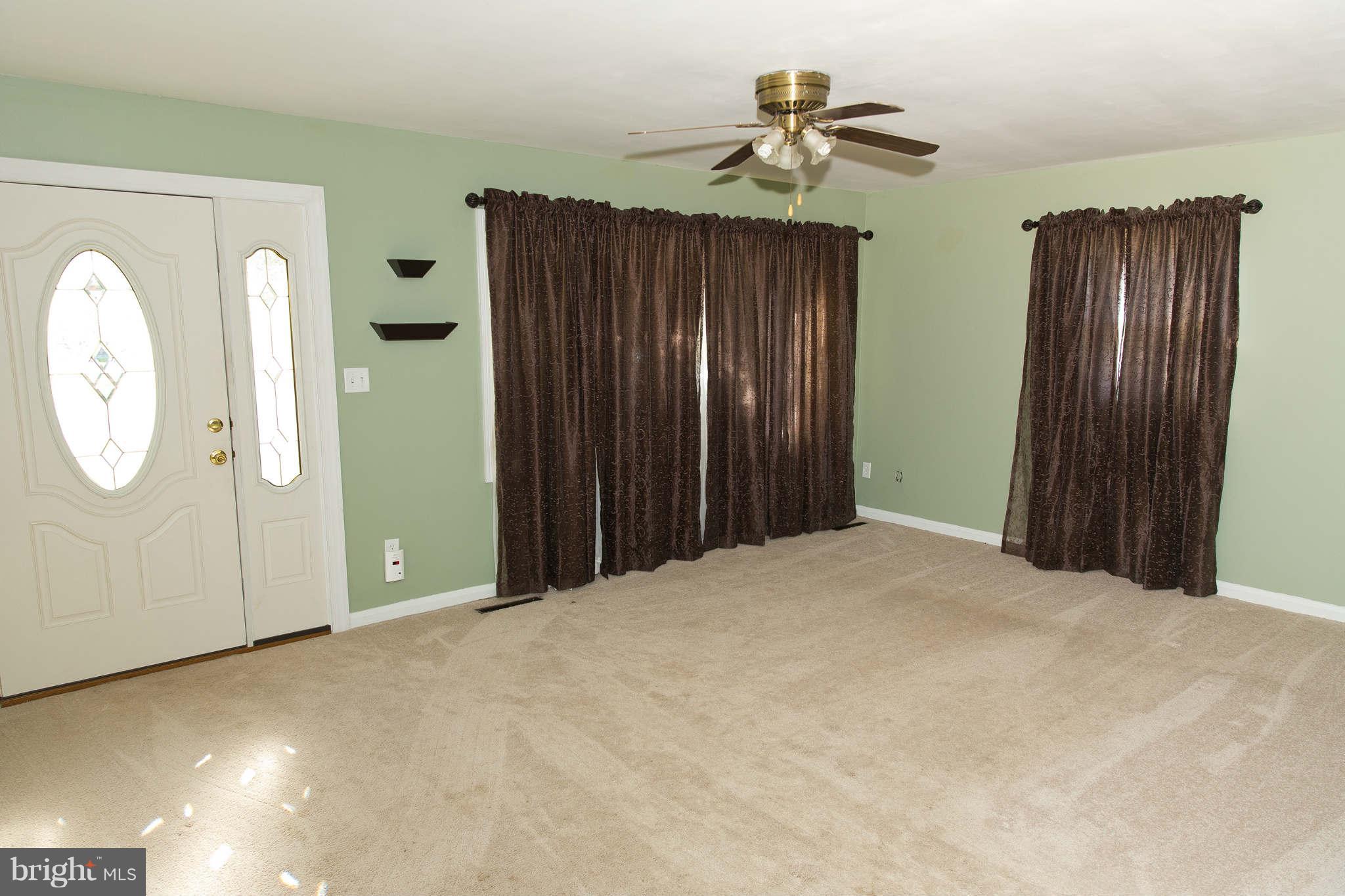 1012 Crosby Road Baltimore, MD 21228 - Photo 2 of 24 a view of a room with wooden floor and mirror