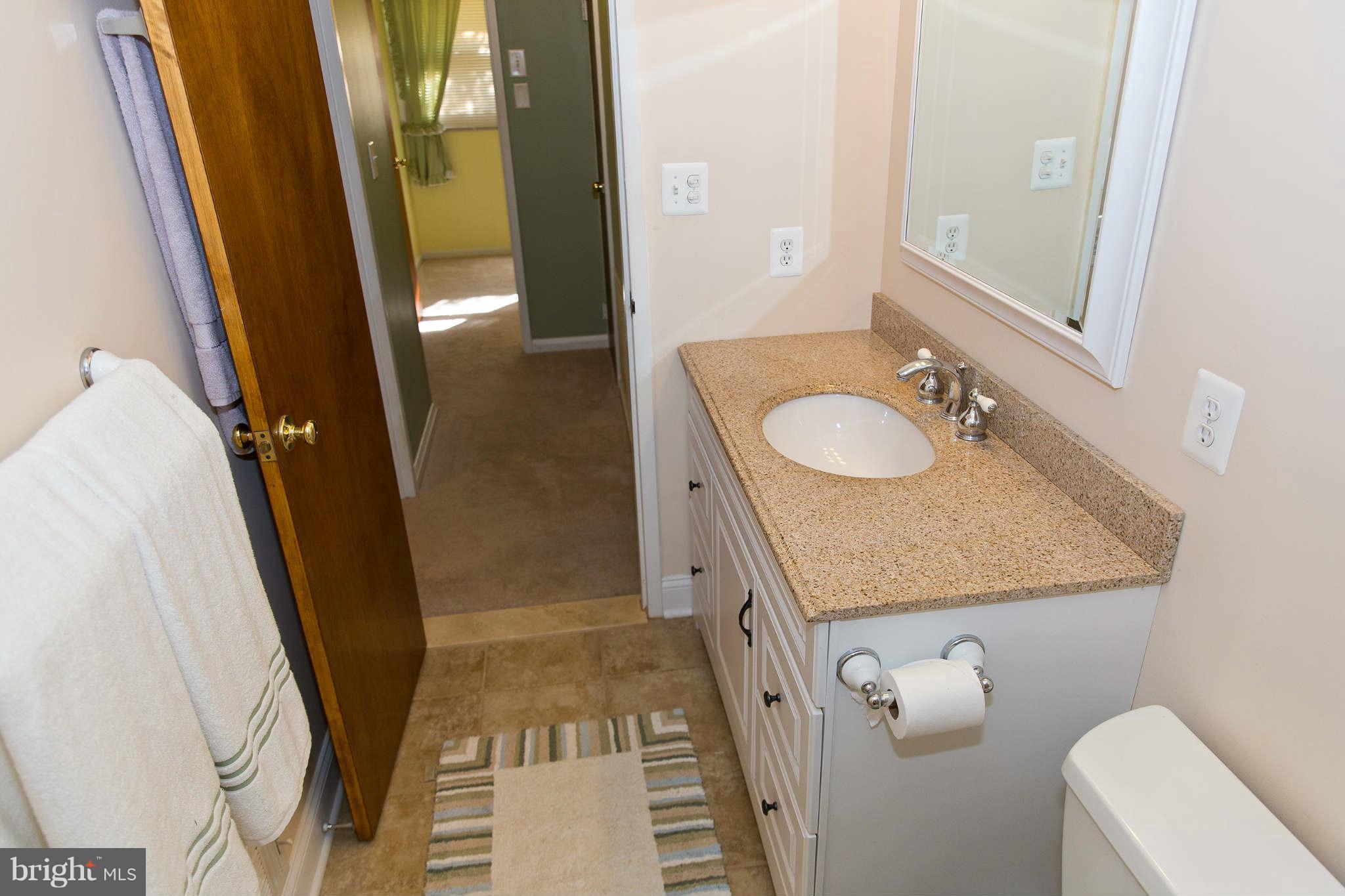 1012 Crosby Road Baltimore, MD 21228 - Photo 12 of 24 a bathroom with a granite countertop sink and a mirror