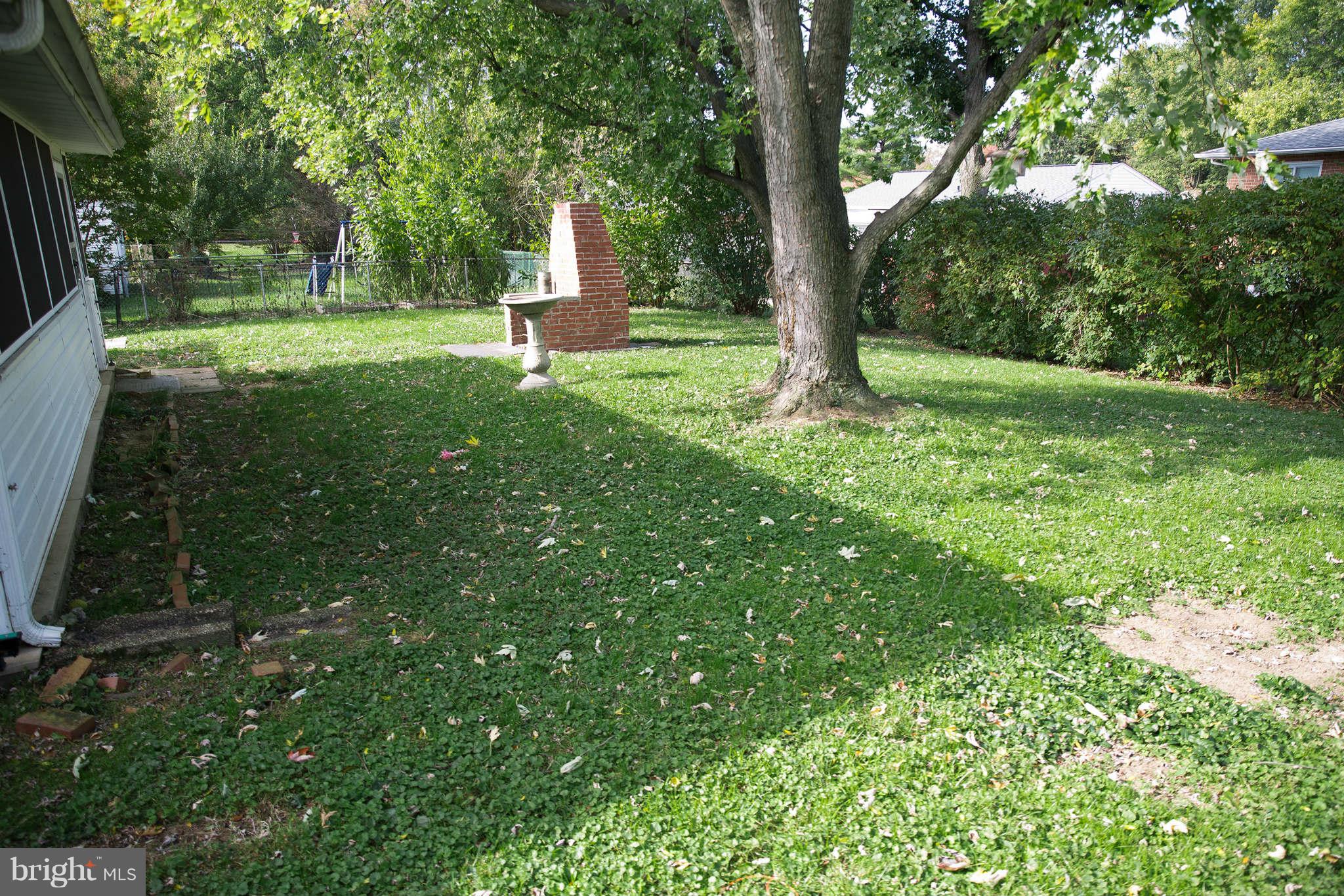 1012 Crosby Road Baltimore, MD 21228 - Photo 19 of 24 a view of a backyard with large trees
