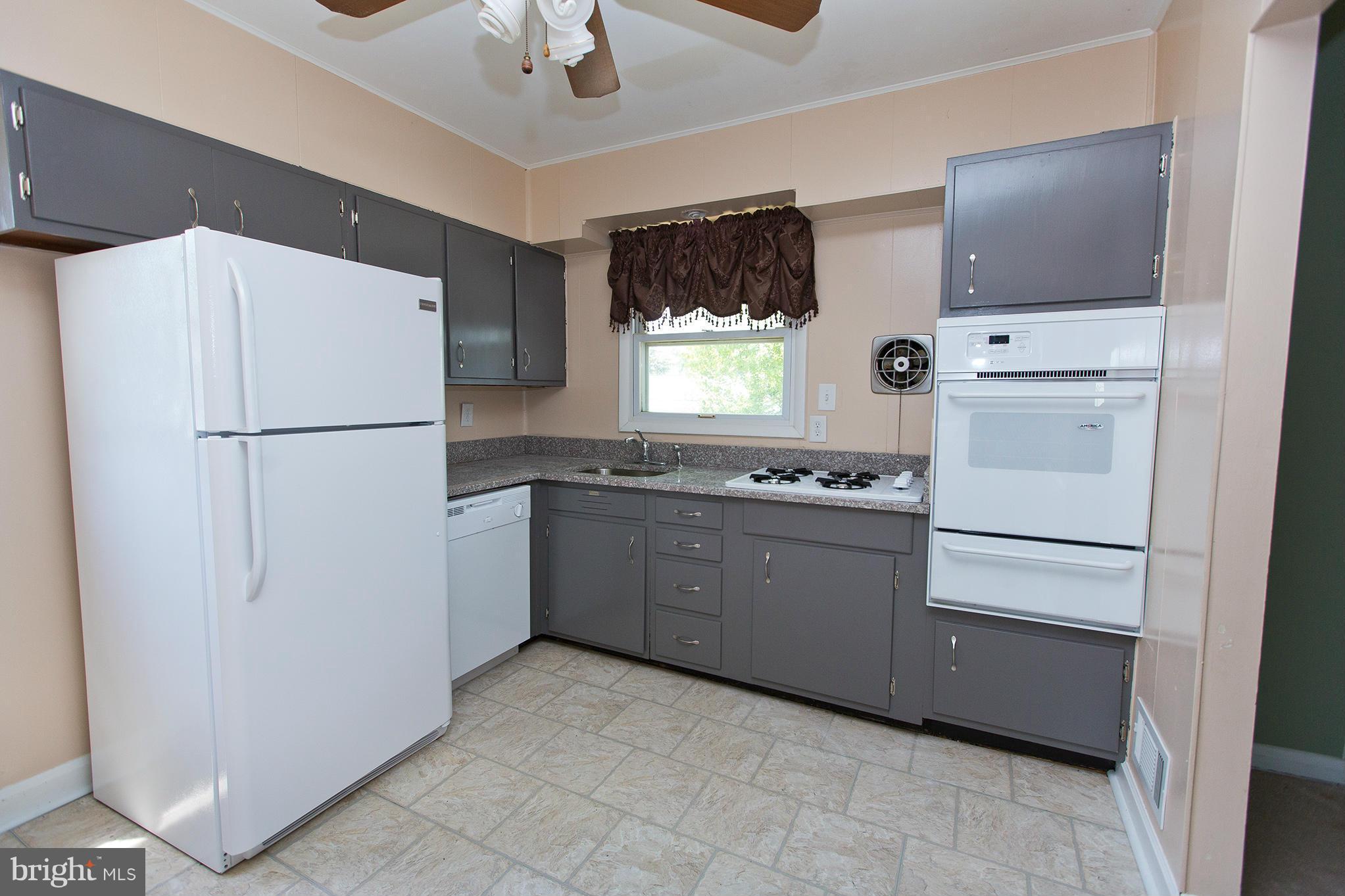 1012 Crosby Road Baltimore, MD 21228 - Photo 5 of 24 a white refrigerator freezer sitting inside of a kitchen