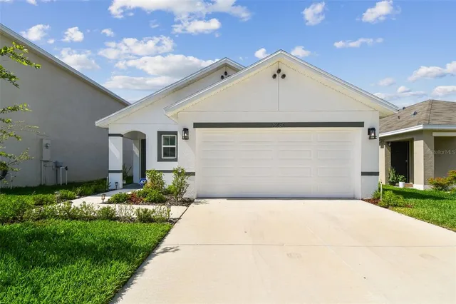 a front view of a house with a yard and garage