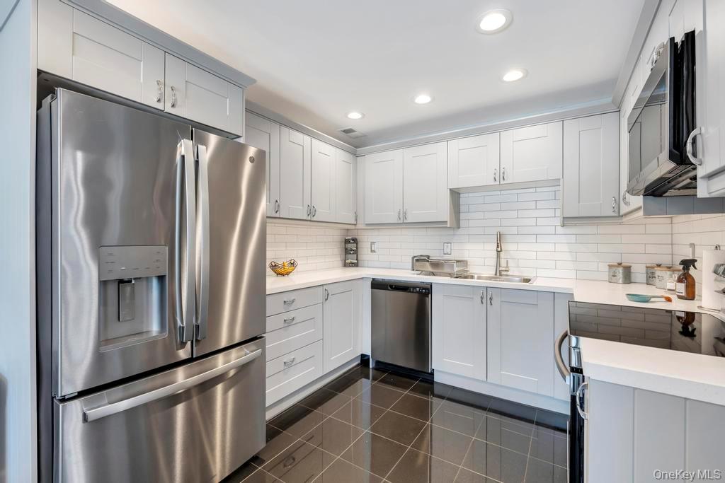 a kitchen with a sink stainless steel appliances and cabinets
