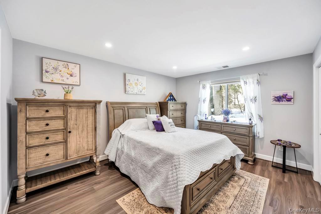 114 Birchwood Road Coram, NY 11727 - Photo 17 of 24 a bedroom with a large bed and a window