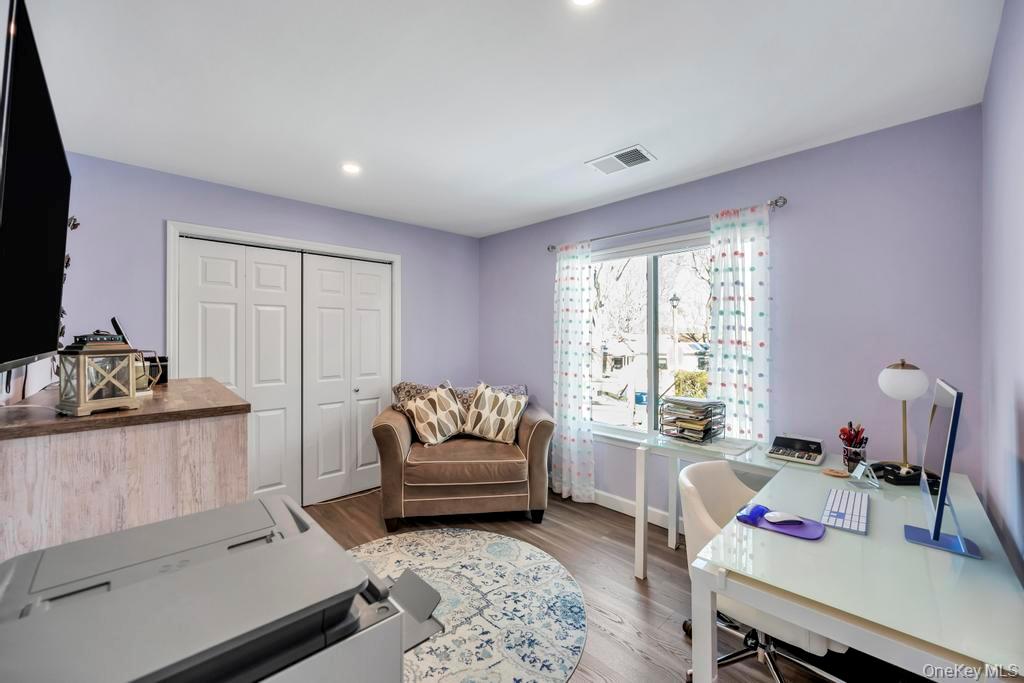 114 Birchwood Road Coram, NY 11727 - Photo 21 of 24 a living room with furniture and a flat screen tv