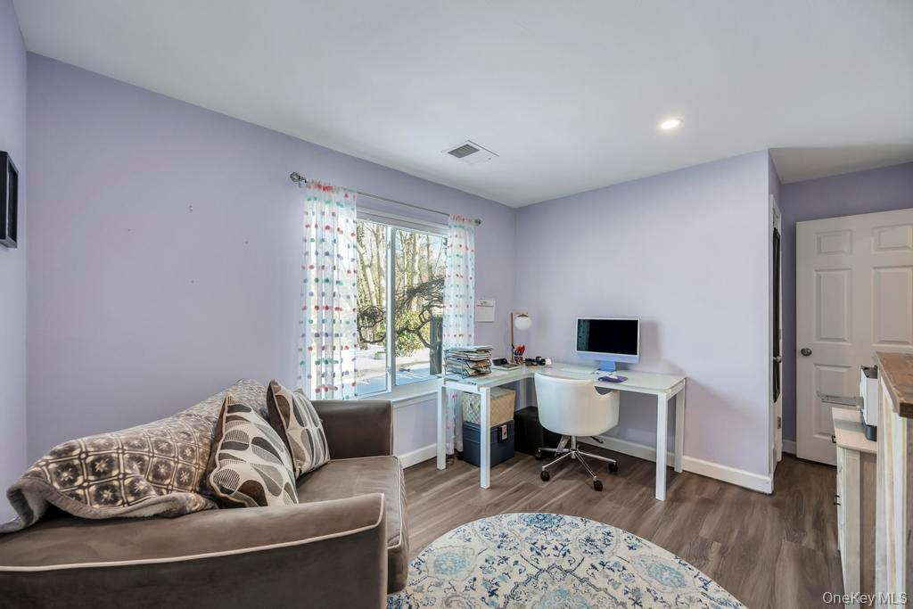 114 Birchwood Road Coram, NY 11727 - Photo 22 of 24 a living room with furniture and a window