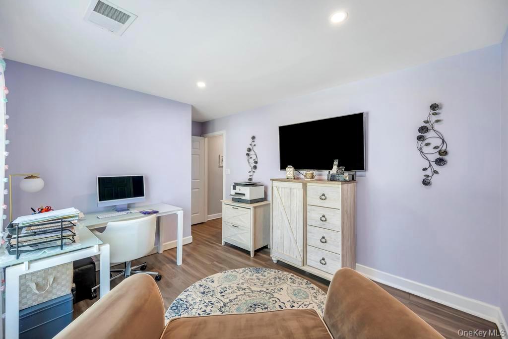 114 Birchwood Road Coram, NY 11727 - Photo 23 of 24 a living room with flat screen tv and washer