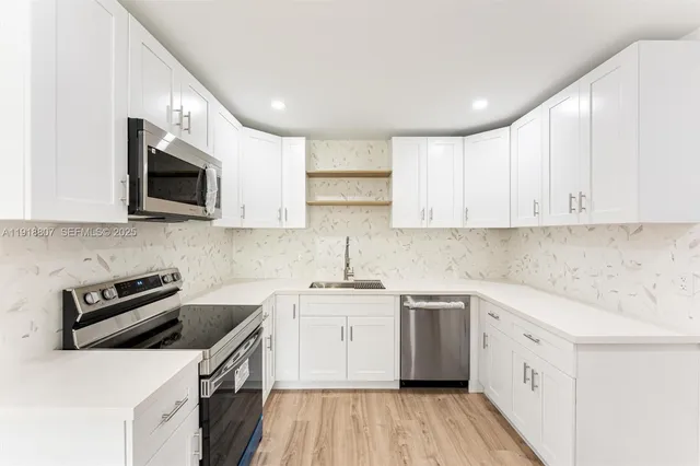 a kitchen with a sink stove and cabinets