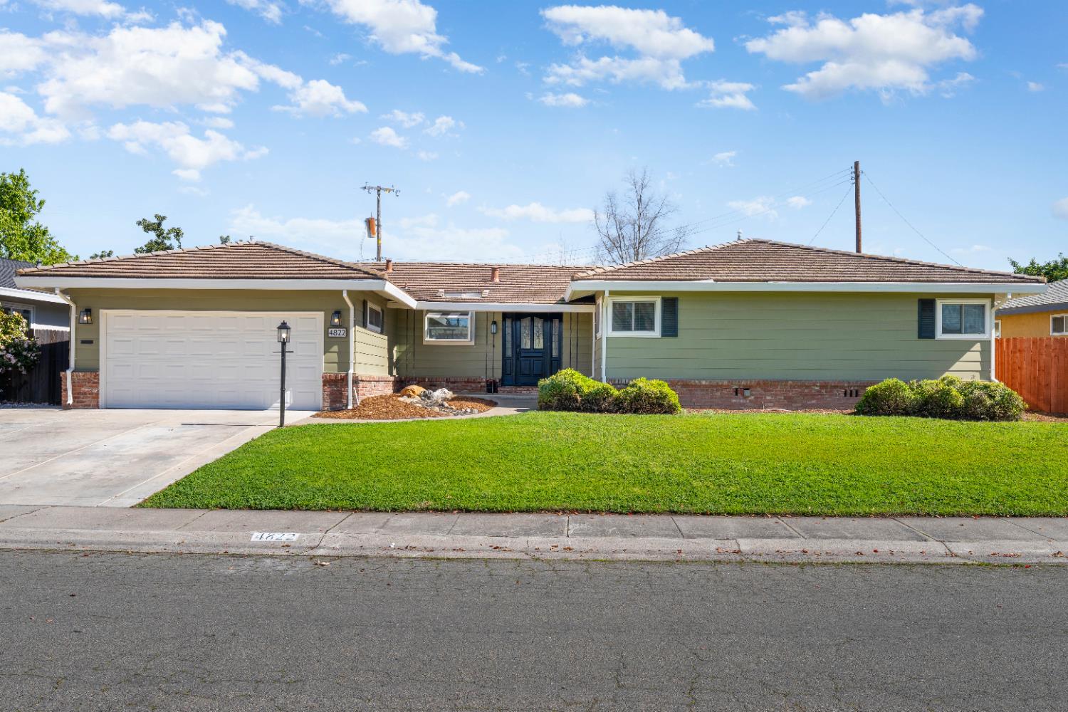4822 Cameron Ranch Drive Carmichael, CA 95608 - Photo 1 of 1 a front view of a house with a garden and plants