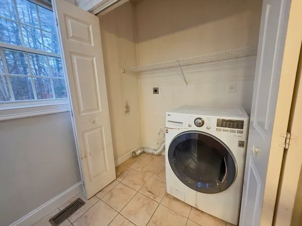 a view of a hallway with washer and dryer