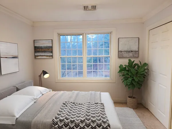 a bedroom with a bed and a window