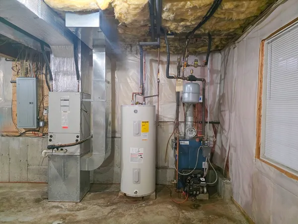 a view of a storage room with water heater and racks