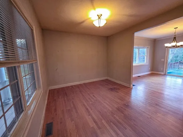 wooden floor in an empty room with a window