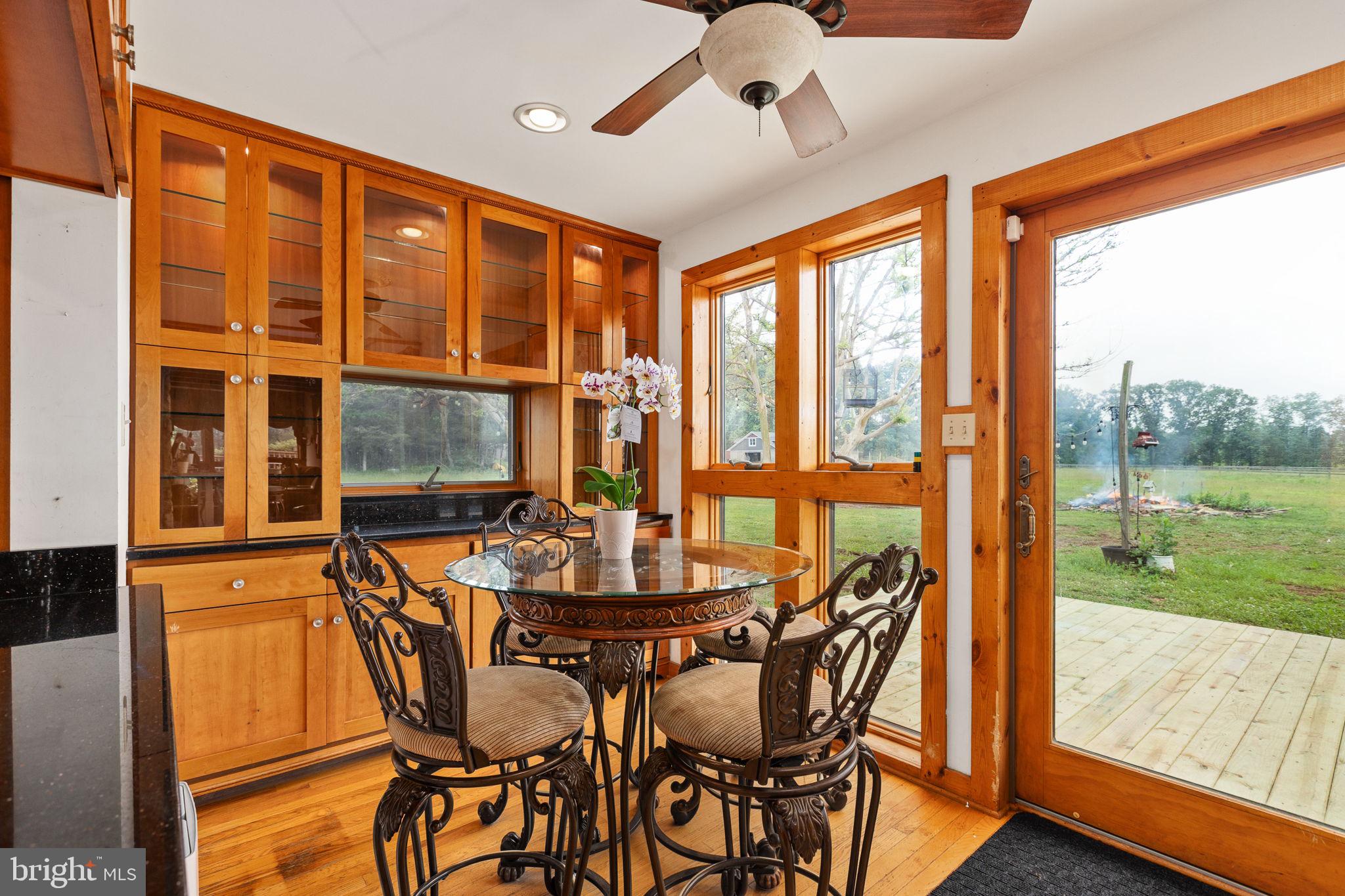 6119 Beach Road Midland, VA 22728 - Photo 38 of 98 a dining room with large windows and wooden floor
