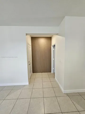 a view of a livingroom with an empty space and a window